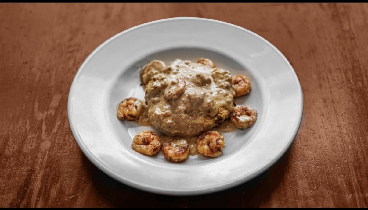 Shrimp and grits with a cheesy grit cake and creamy seafood sauce
